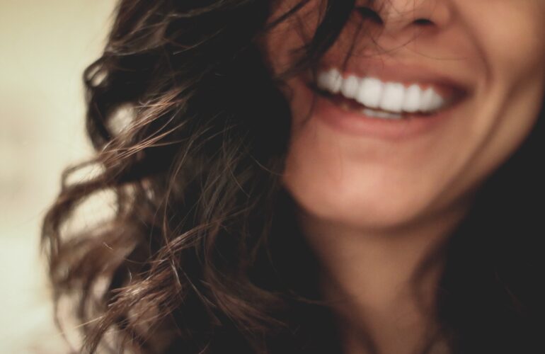 Smiling lady with perfectly aligned white shiny teeth