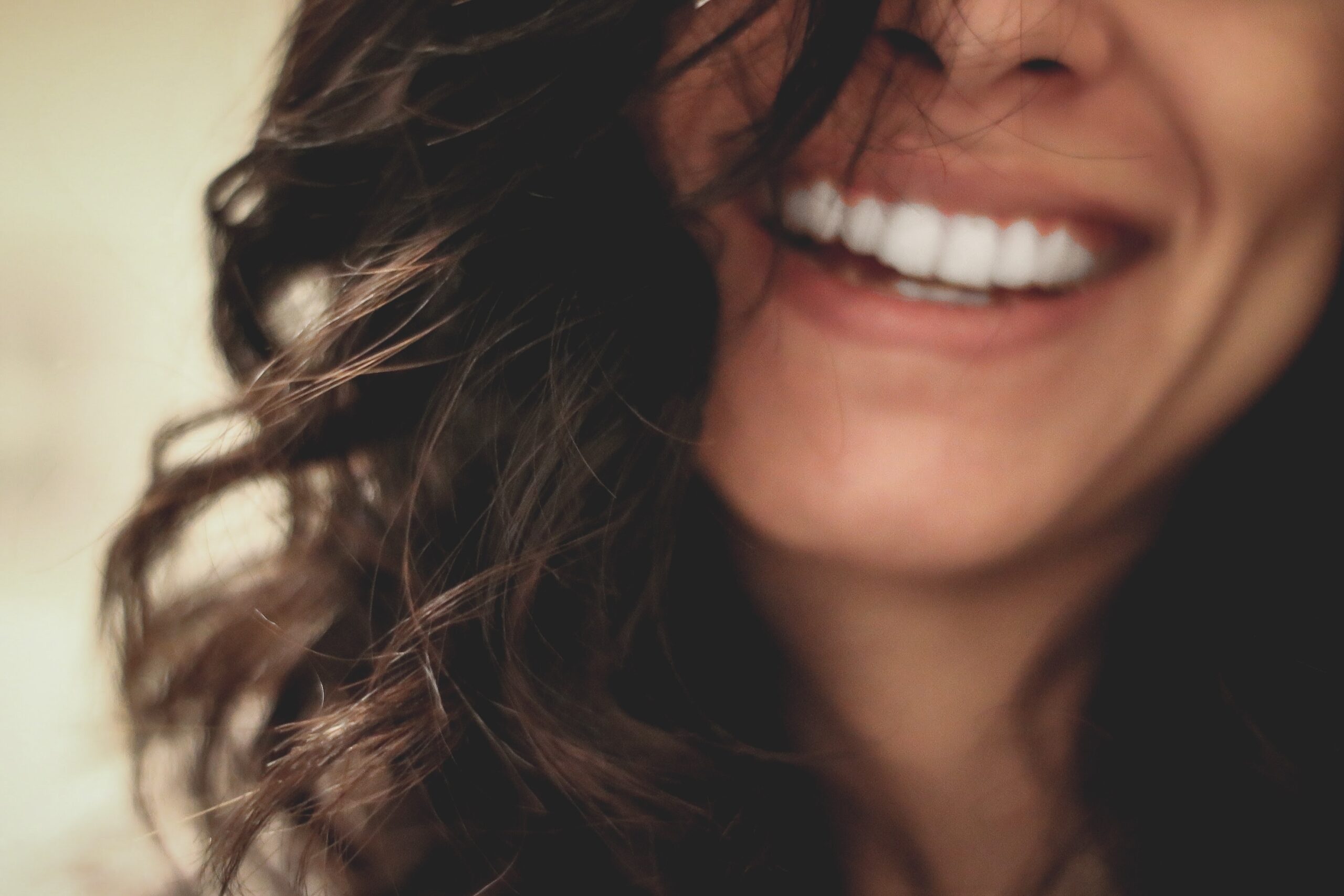 Smiling lady with perfectly aligned white shiny teeth