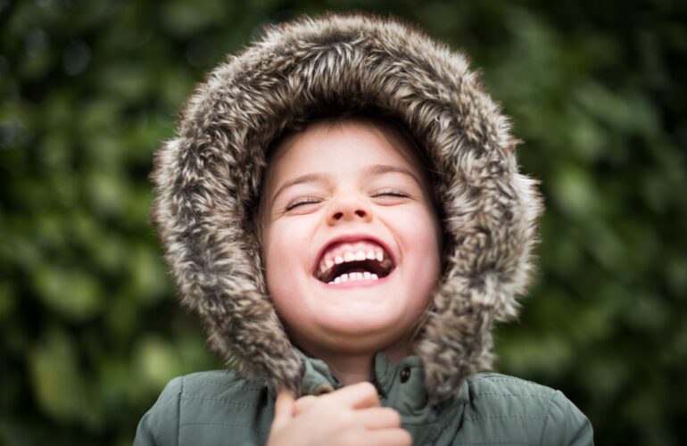 Happy child in fur jacket