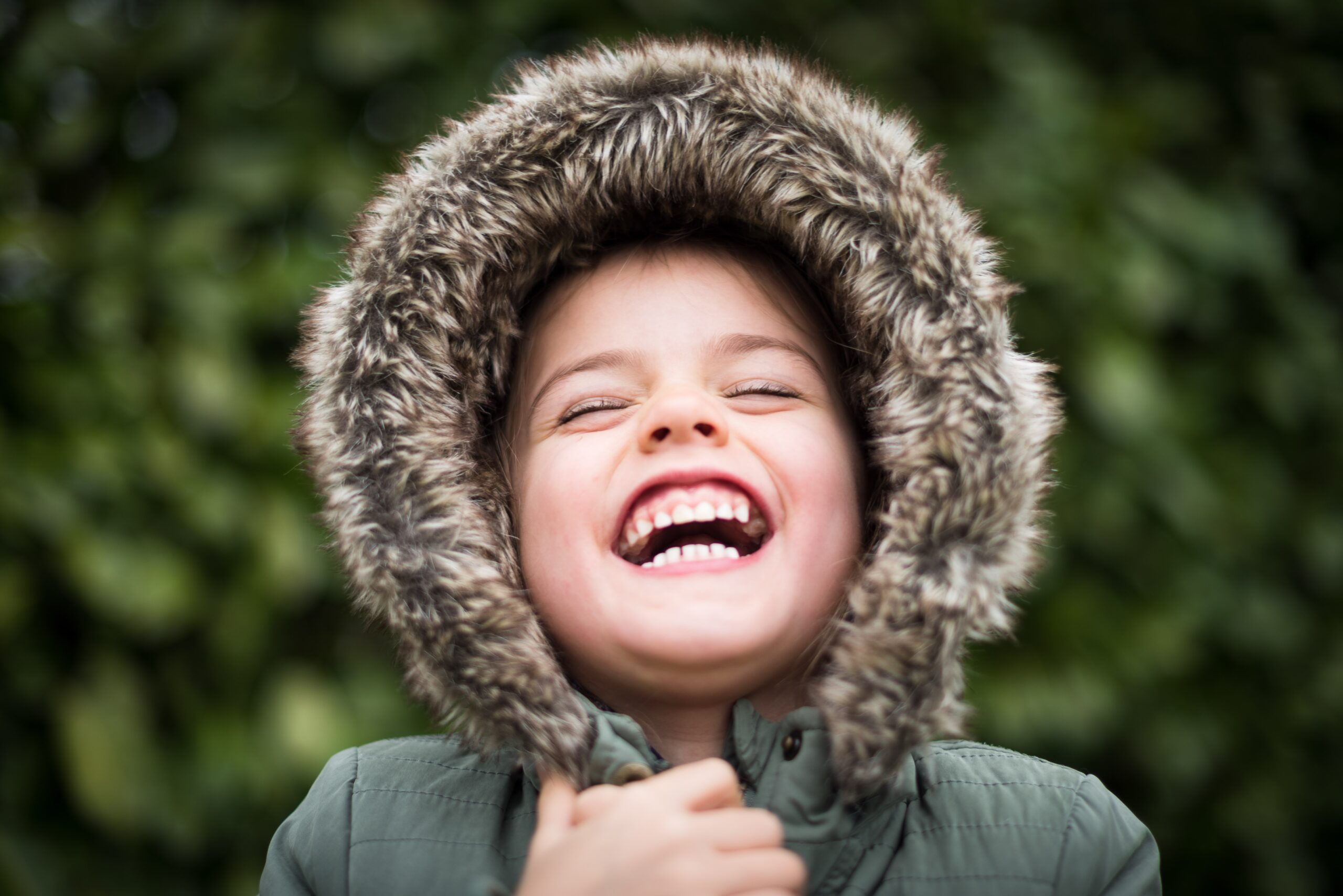 Happy child in fur jacket