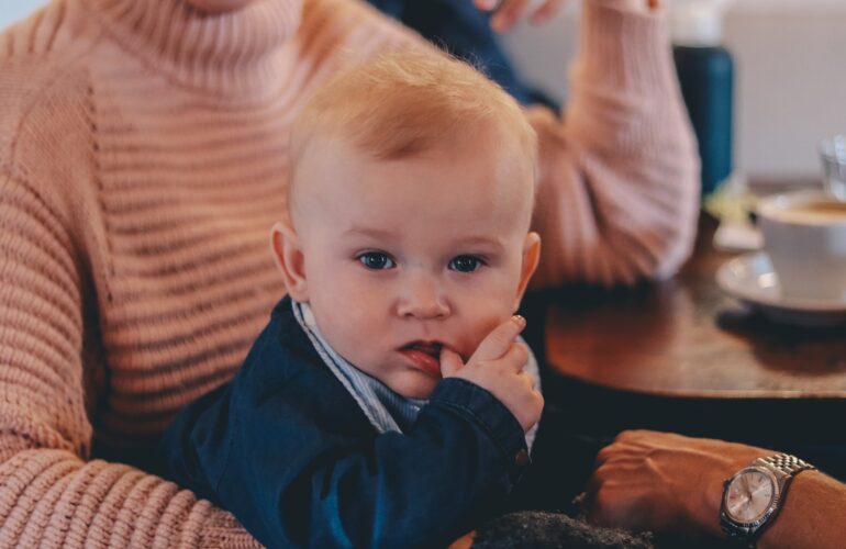 candid photo of baby sucking his thumb