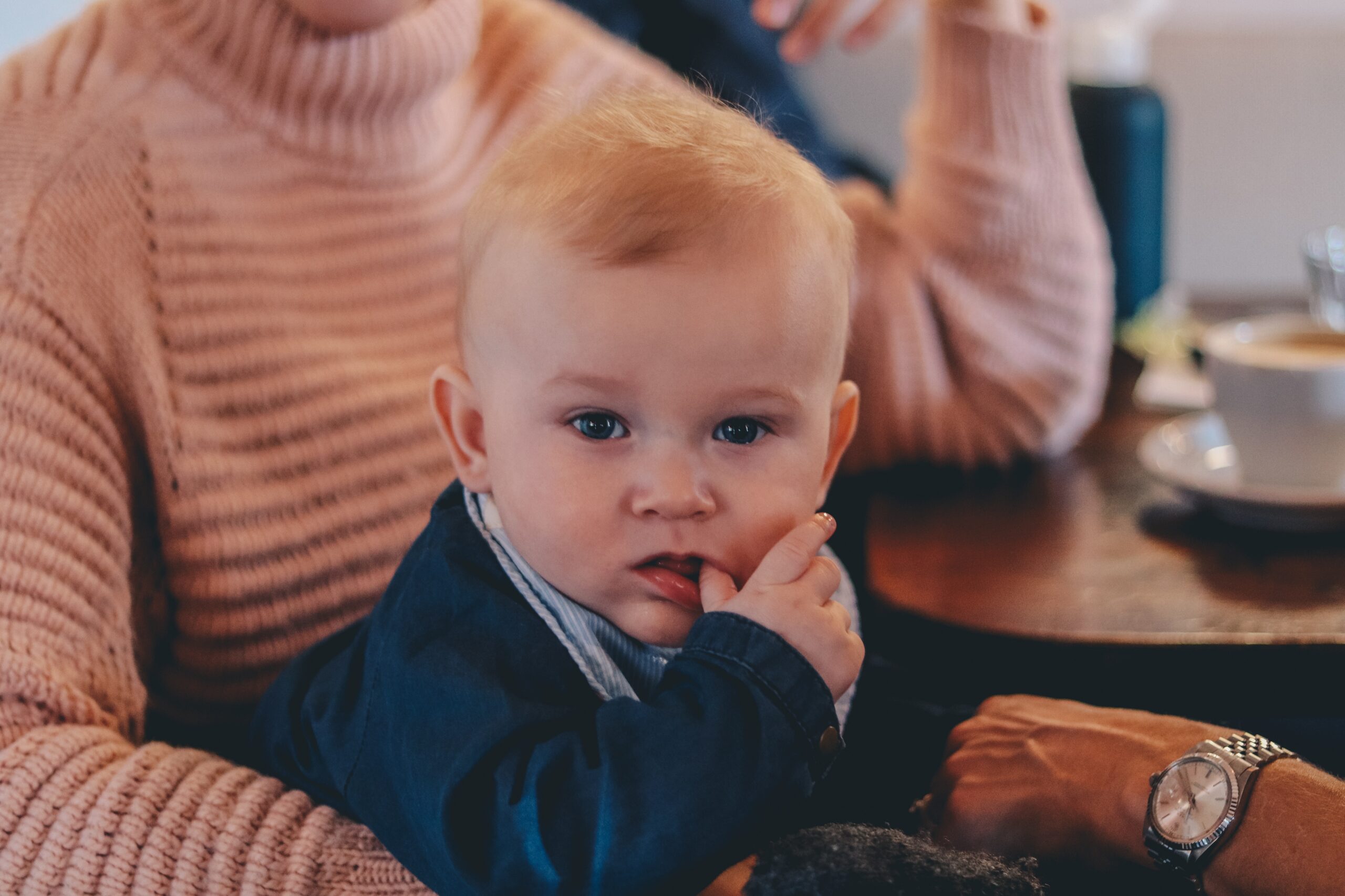 candid photo of baby sucking his thumb